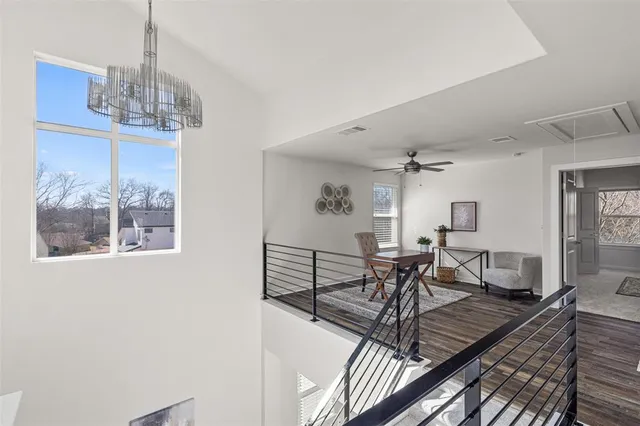 a view of a dining room with furniture a chandelier and wooden floor