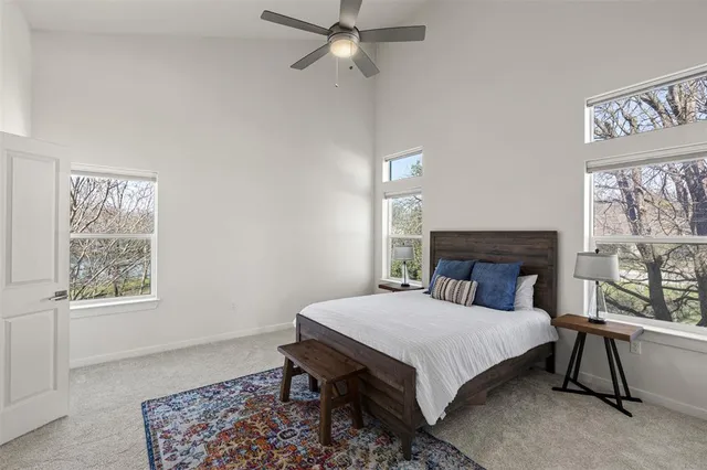 a bed sitting in a bedroom next to a window