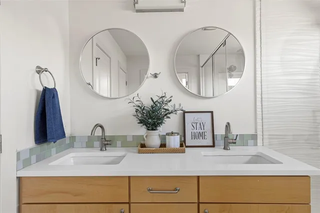 a bathroom with a double vanity sink and a mirror