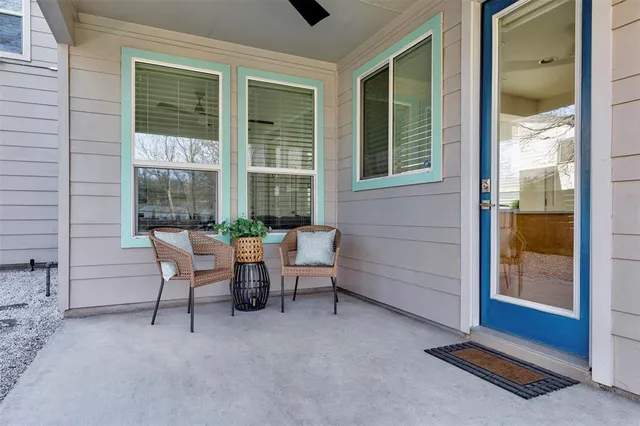 a view of a two chairs in the room and a window
