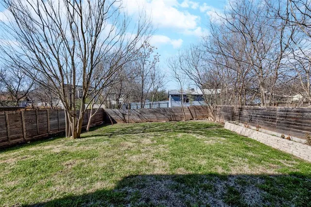 a view of a backyard with large trees