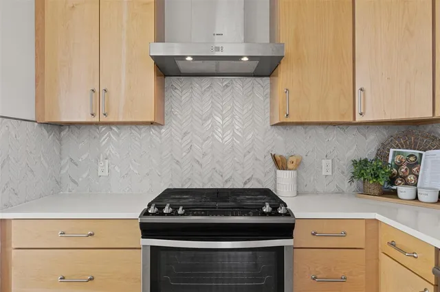 a stove top oven sitting inside of a kitchen