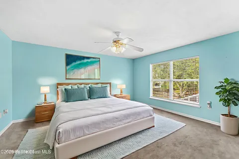 a bedroom with a large bed and a window