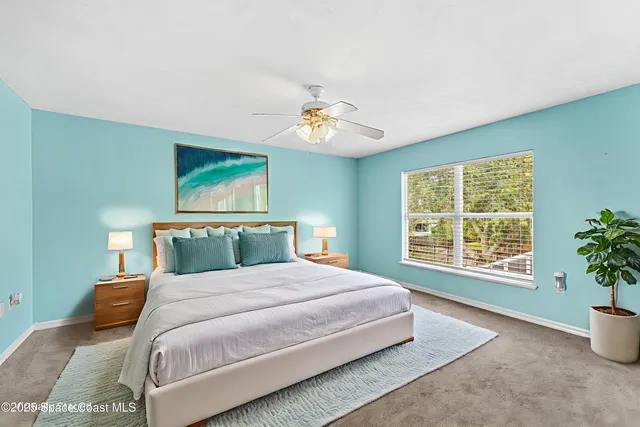 a bedroom with a large bed and a window