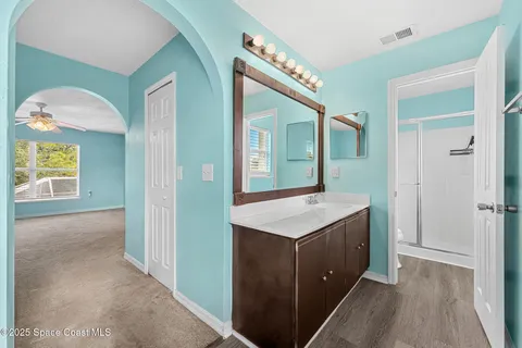 a hall with a sink a mirror and a vanity