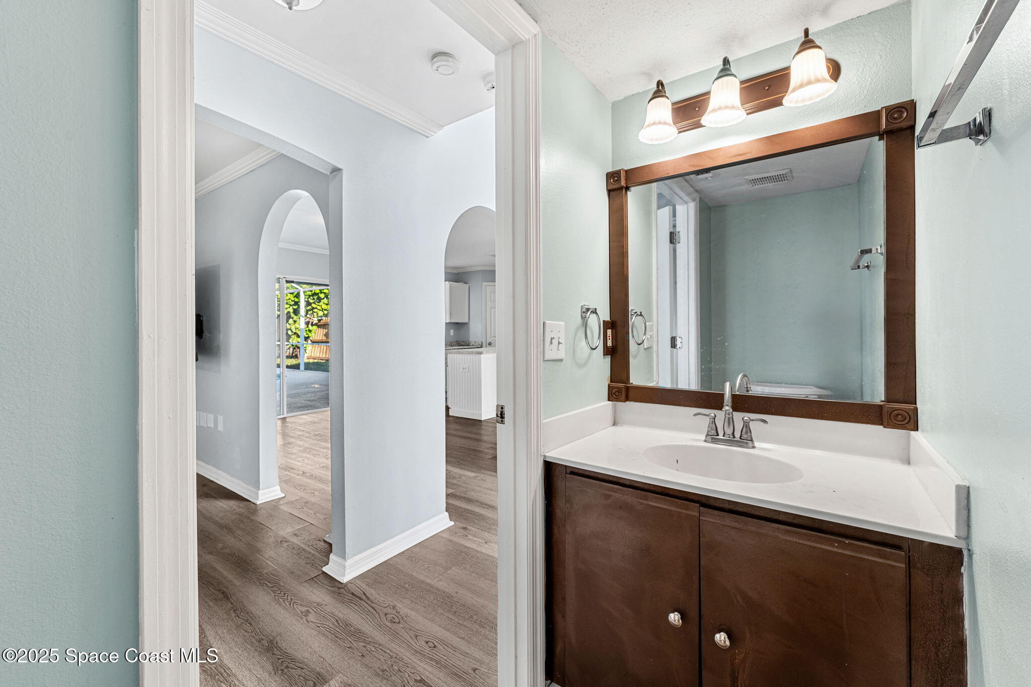 1249 White Oak Circle Melbourne, FL 32934 - Photo 15 of 34 a en suite bathroom with a sink and mirror
