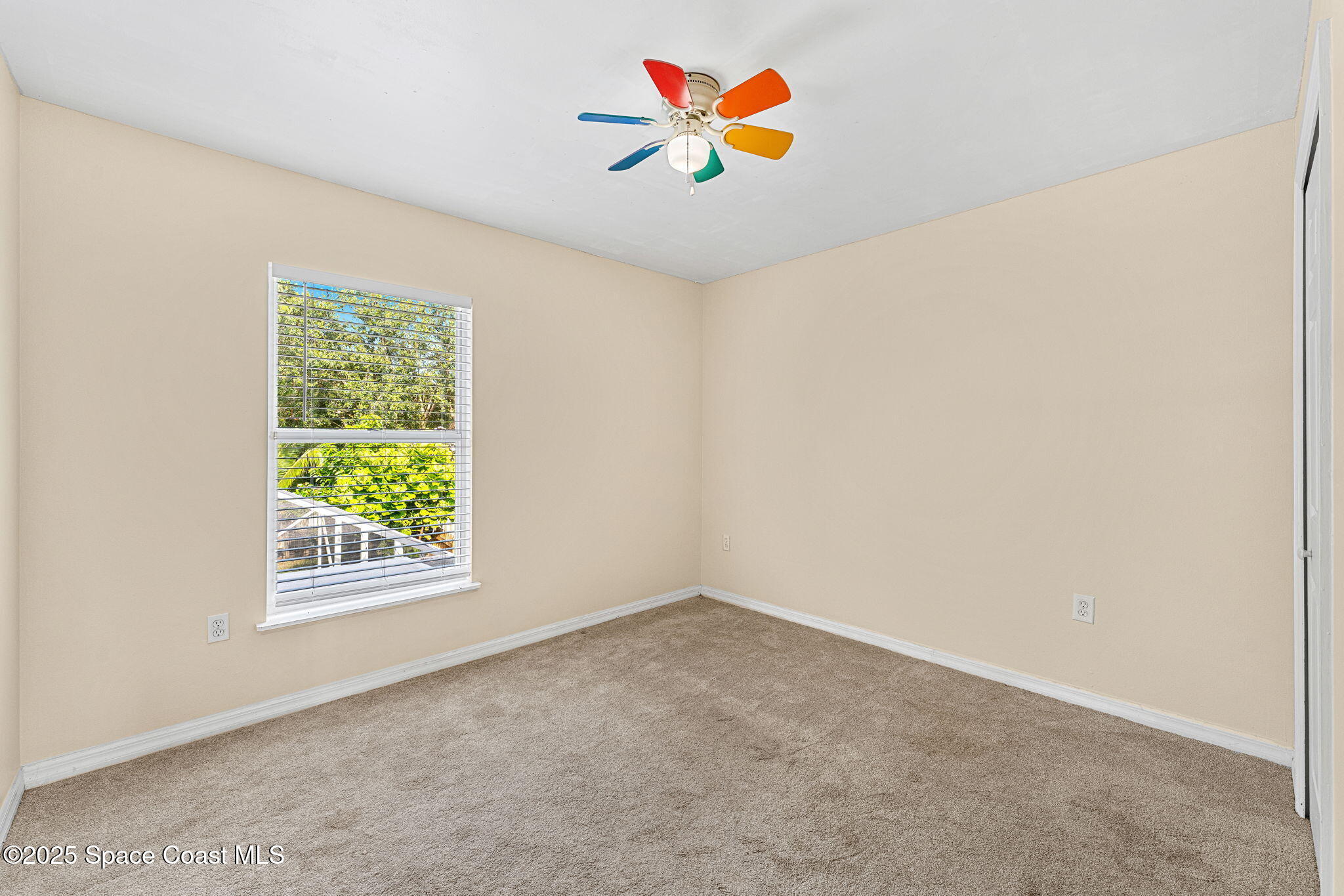 1249 White Oak Circle Melbourne, FL 32934 - Photo 17 of 34 an empty room with a window and a ceiling fan