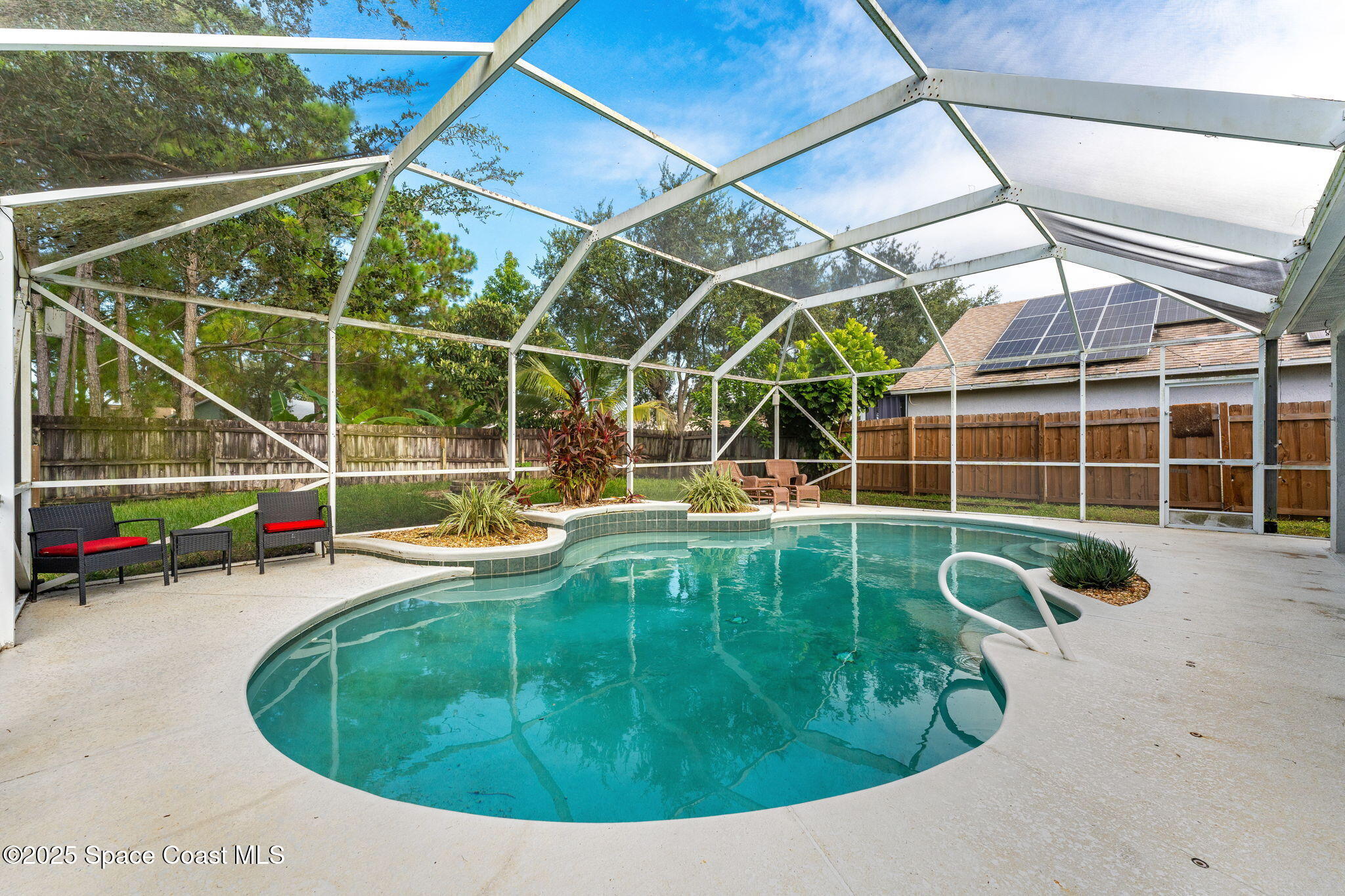 1249 White Oak Circle Melbourne, FL 32934 - Photo 2 of 34 a view of a swimming pool with a yard and wooden fence