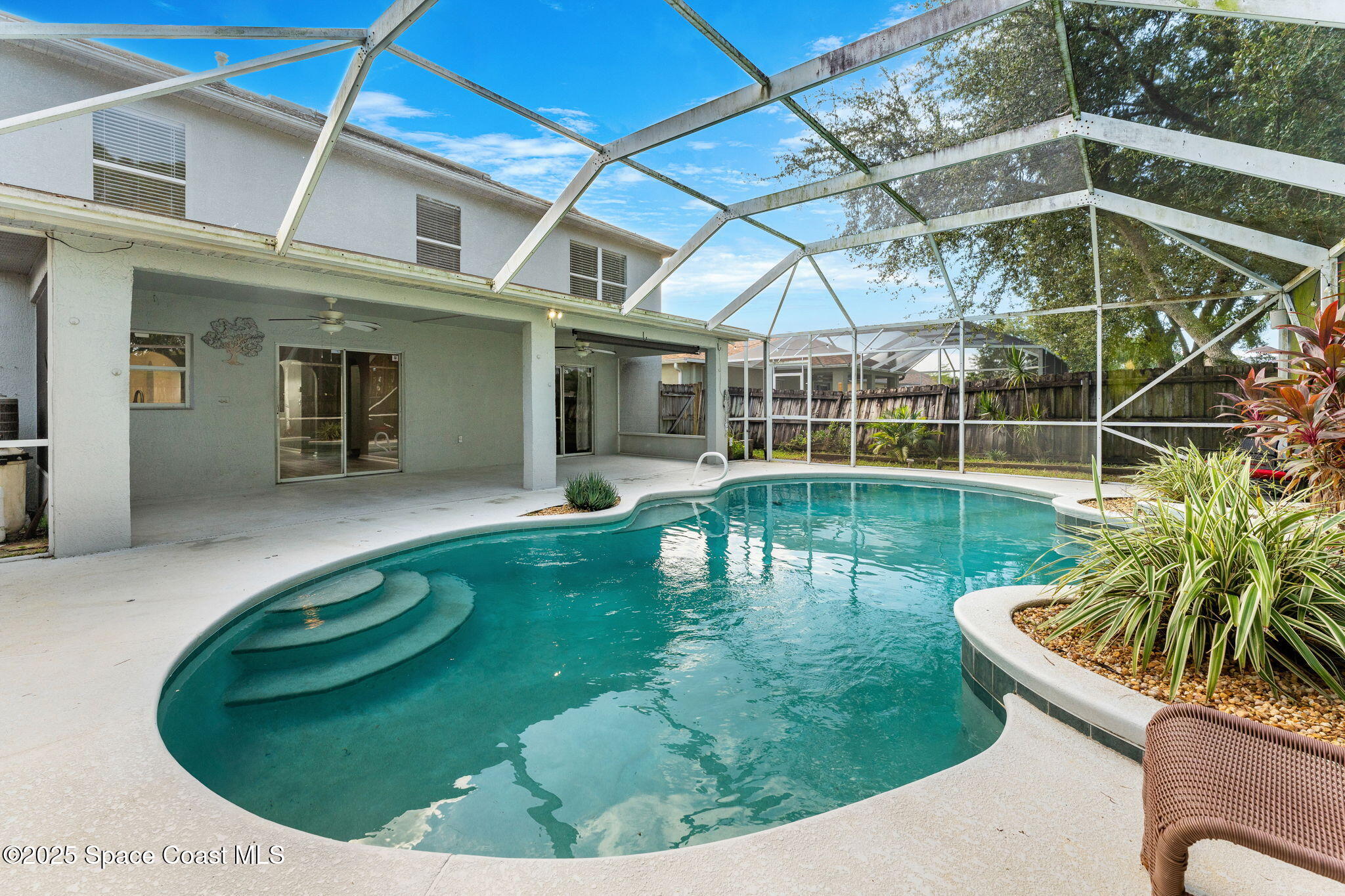 1249 White Oak Circle Melbourne, FL 32934 - Photo 21 of 34 a view of a swimming pool with a patio