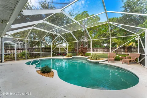 a view of a swimming pool with an outdoor and sitting space