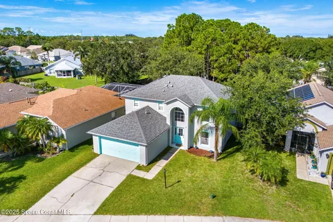 an aerial view of a house with a garden
