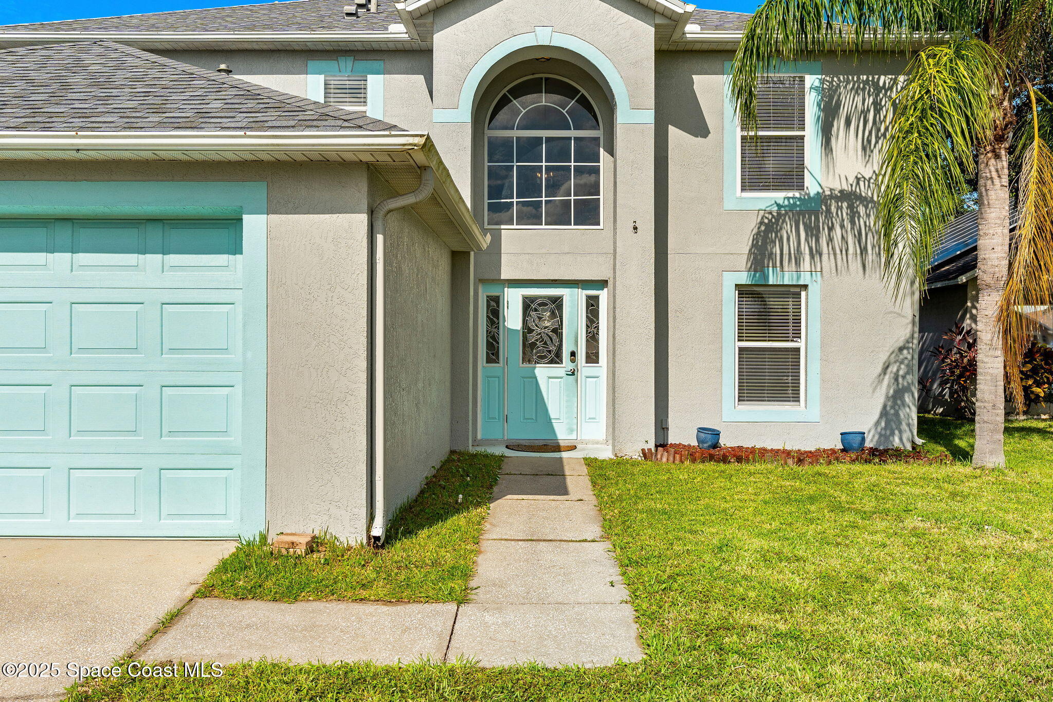 1249 White Oak Circle Melbourne, FL 32934 - Photo 3 of 34 a front view of a house with a yard