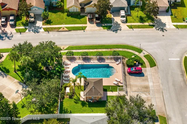 an aerial view of a house with a swimming pool yard and outdoor seating