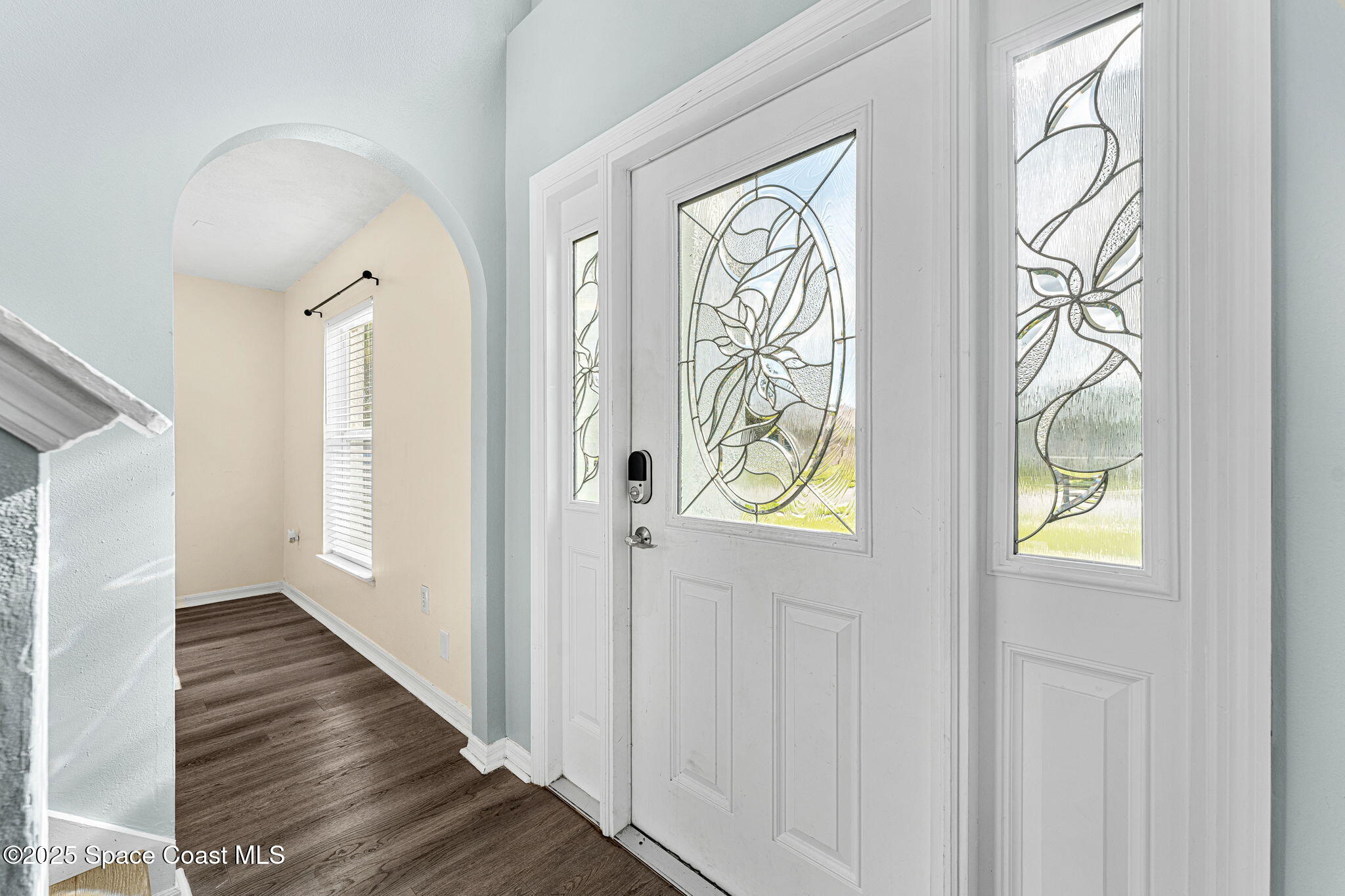 1249 White Oak Circle Melbourne, FL 32934 - Photo 4 of 34 a view of an entryway with wooden floor and a window