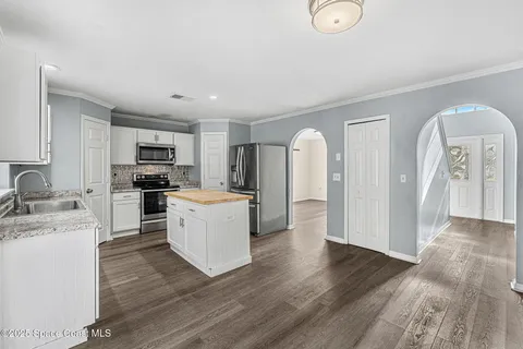 a kitchen with refrigerator and cabinets