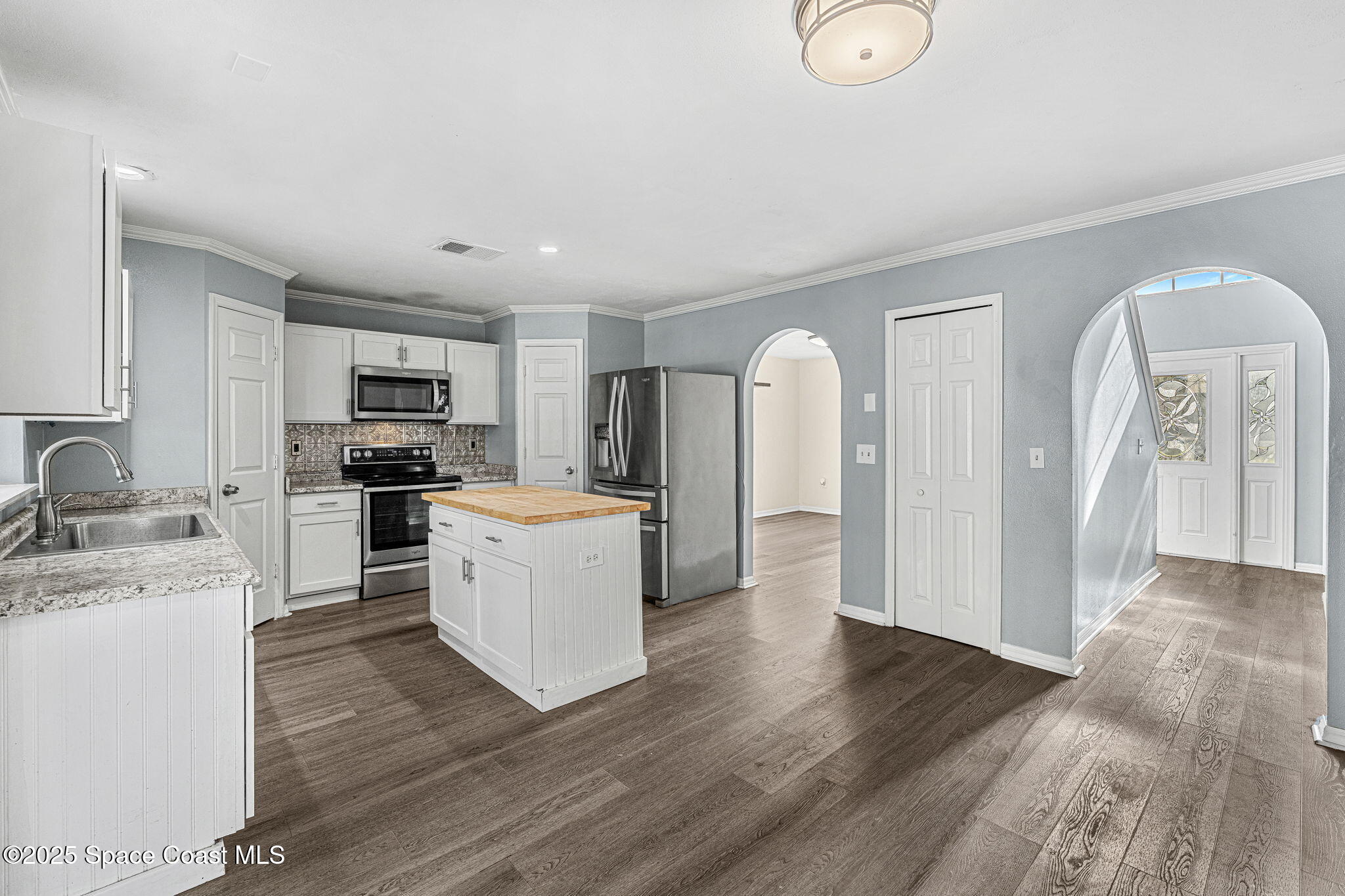 1249 White Oak Circle Melbourne, FL 32934 - Photo 5 of 34 a kitchen with refrigerator and cabinets