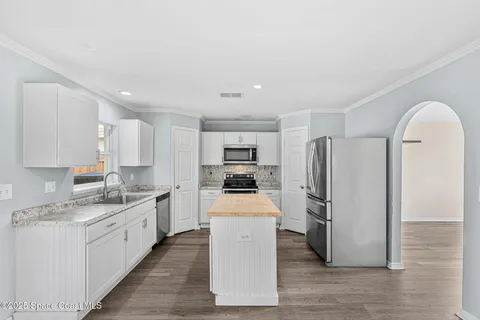 a kitchen with a refrigerator sink and stainless steel appliances