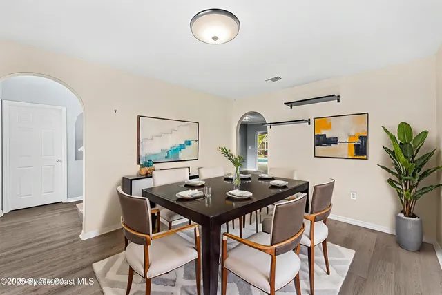 a view of a dining room with furniture and wooden floor