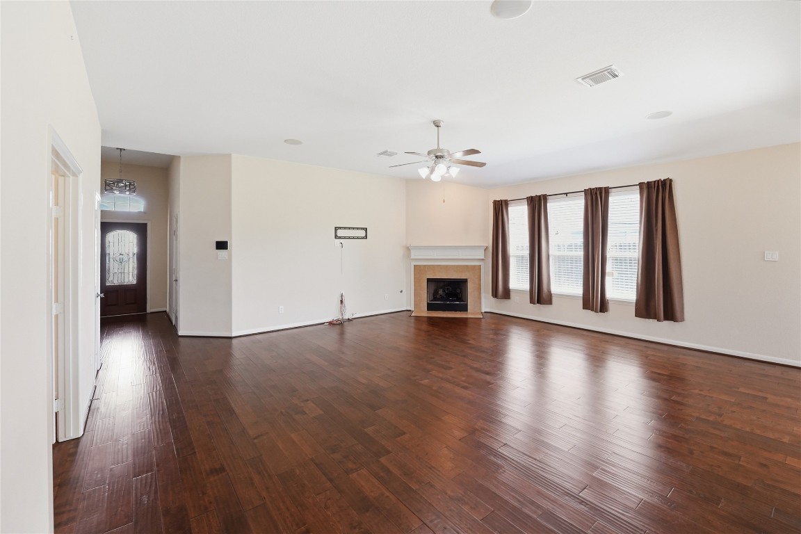5803 Deleon Trail Drive Spring, TX 77379 - Photo 12 of 33 a view of an empty room with window and wooden floor