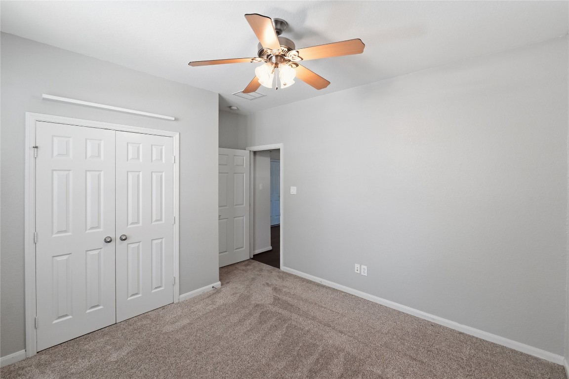 5803 Deleon Trail Drive Spring, TX 77379 - Photo 21 of 33 an empty room with a ceiling fan and a window