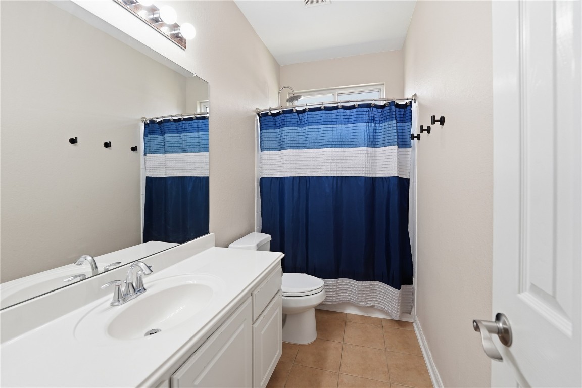 5803 Deleon Trail Drive Spring, TX 77379 - Photo 23 of 33 a bathroom with a sink a toilet and shower