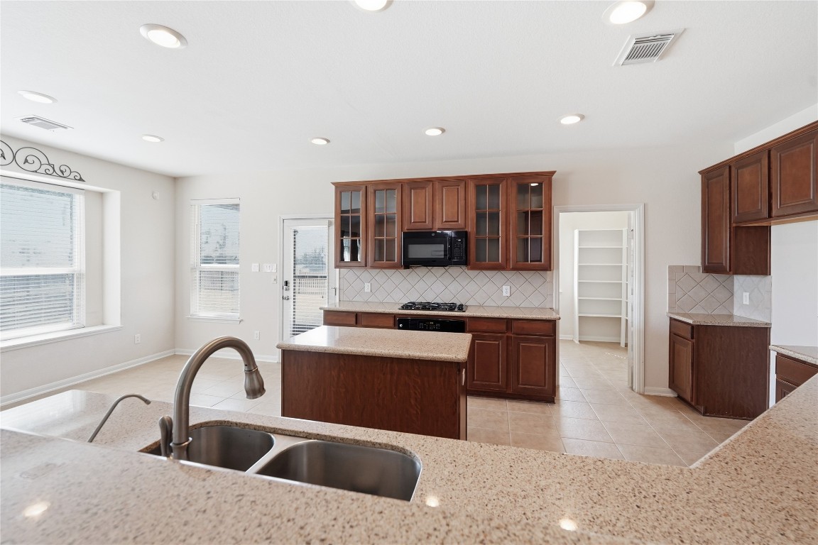5803 Deleon Trail Drive Spring, TX 77379 - Photo 5 of 33 a kitchen with stainless steel appliances granite countertop a white stove top oven and sink