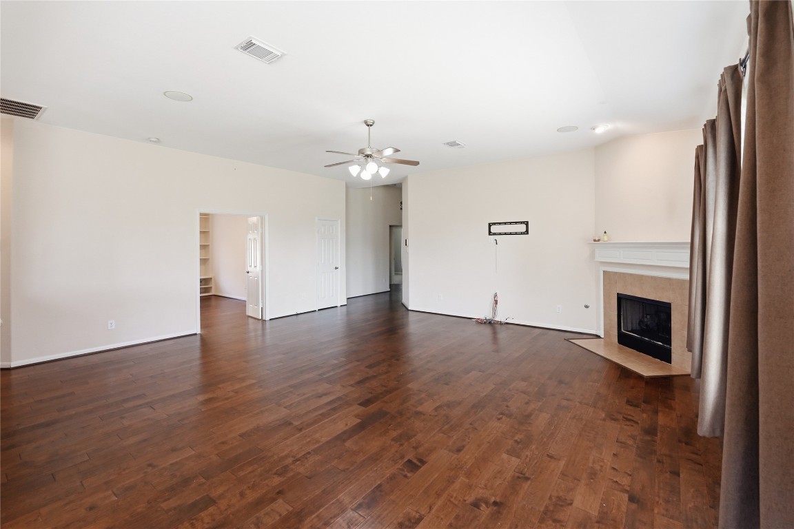 5803 Deleon Trail Drive Spring, TX 77379 - Photo 10 of 33 wooden floor in an empty room with a fireplace