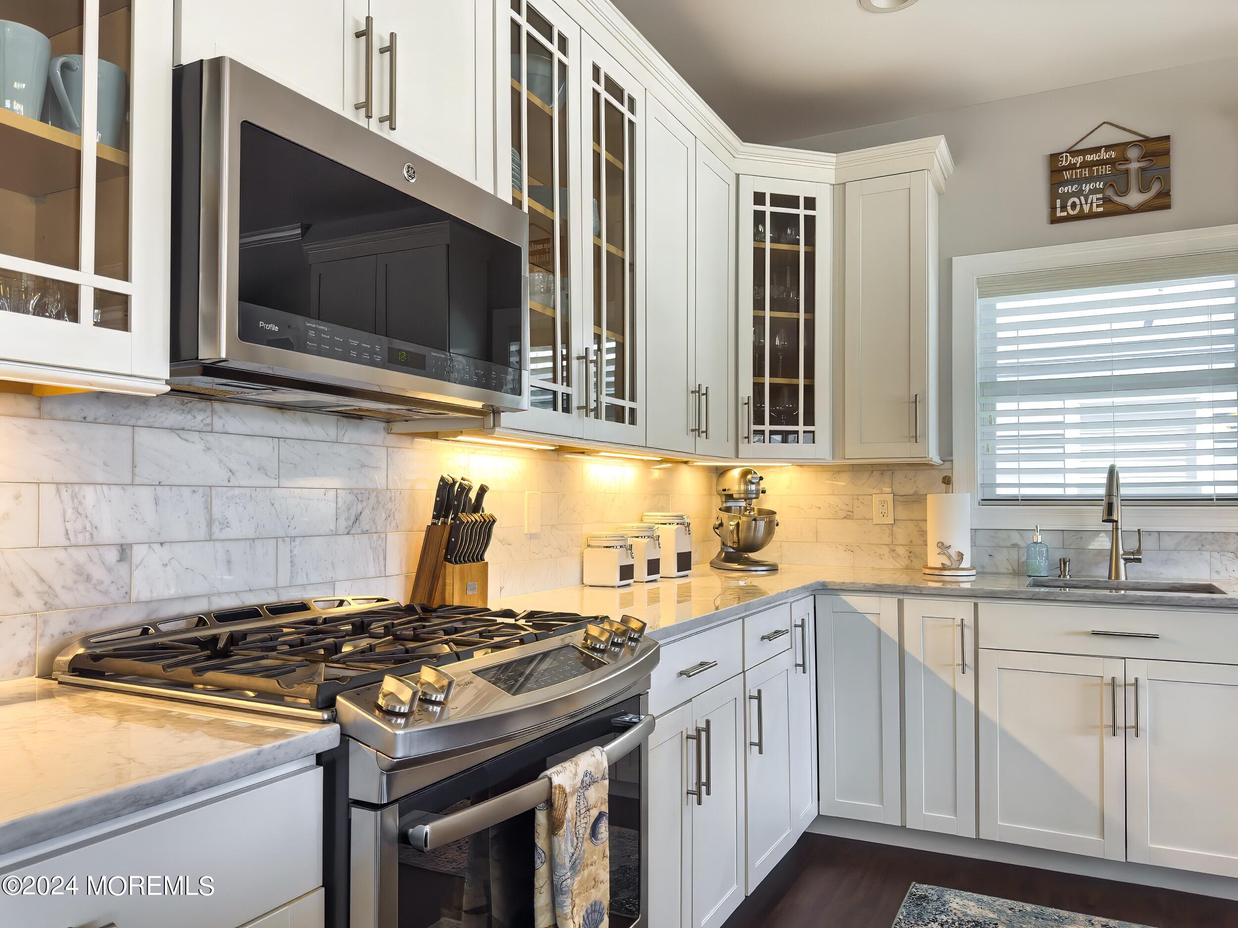 646 Drum Point Road, Unit B Brick, NJ 08723 - Photo 11 of 46 a kitchen with stainless steel appliances a stove a sink and a microwave