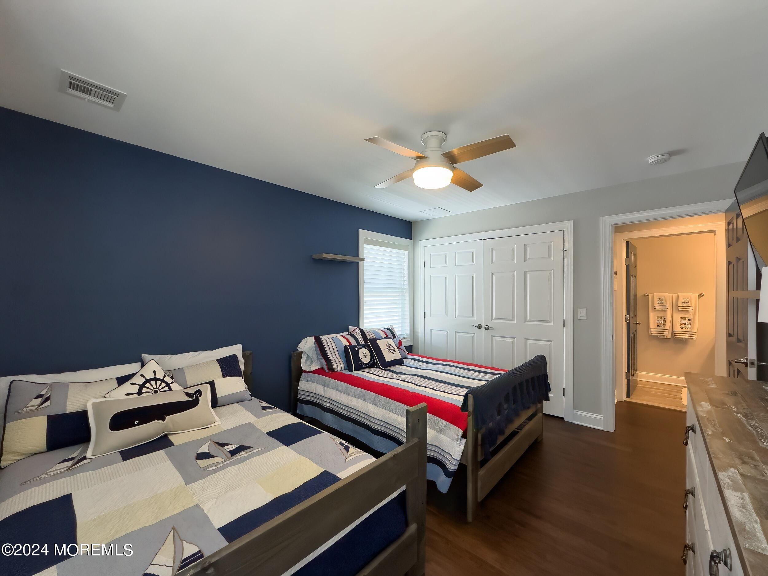 646 Drum Point Road, Unit B Brick, NJ 08723 - Photo 26 of 46 a bedroom with a bed and a chandelier