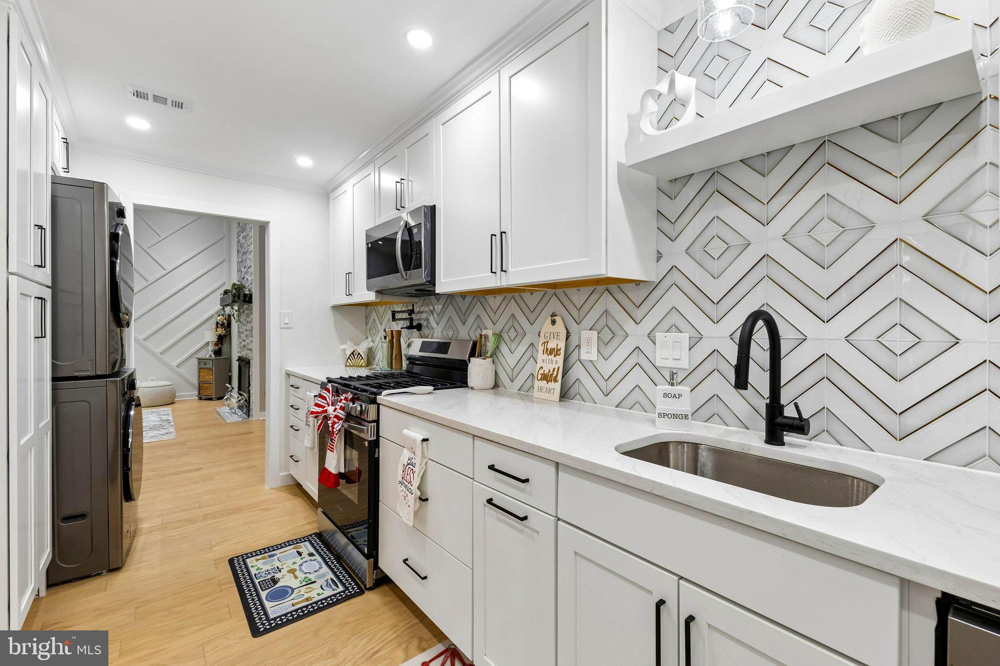 11841 Shire Court, Unit 31D Reston, VA 20191 - Photo 15 of 24 a kitchen with stainless steel appliances granite countertop a sink and a refrigerator