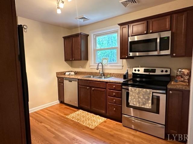 114 Coffee Road Lynchburg, VA 24503 - Photo 6 of 25 a kitchen with stainless steel appliances granite countertop a stove a sink and a microwave