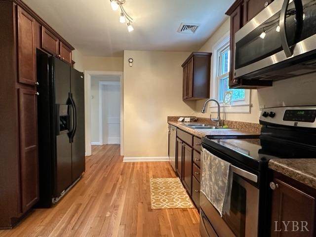 114 Coffee Road Lynchburg, VA 24503 - Photo 7 of 25 a kitchen with stainless steel appliances granite countertop a stove and a sink