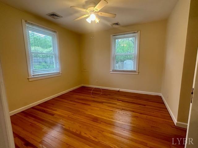 114 Coffee Road Lynchburg, VA 24503 - Photo 9 of 25 a view of an empty room with wooden floor and a window