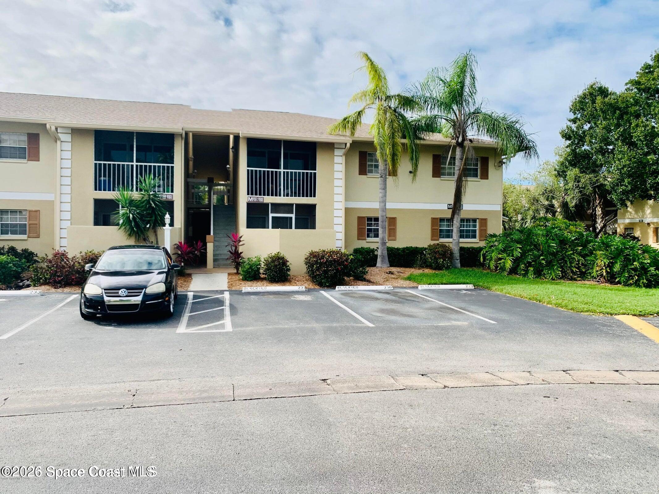 1648 Sunny Brook Lane, Unit M202 Palm Bay, FL 32905 - Photo 1 of 15 a car parked in front of white house