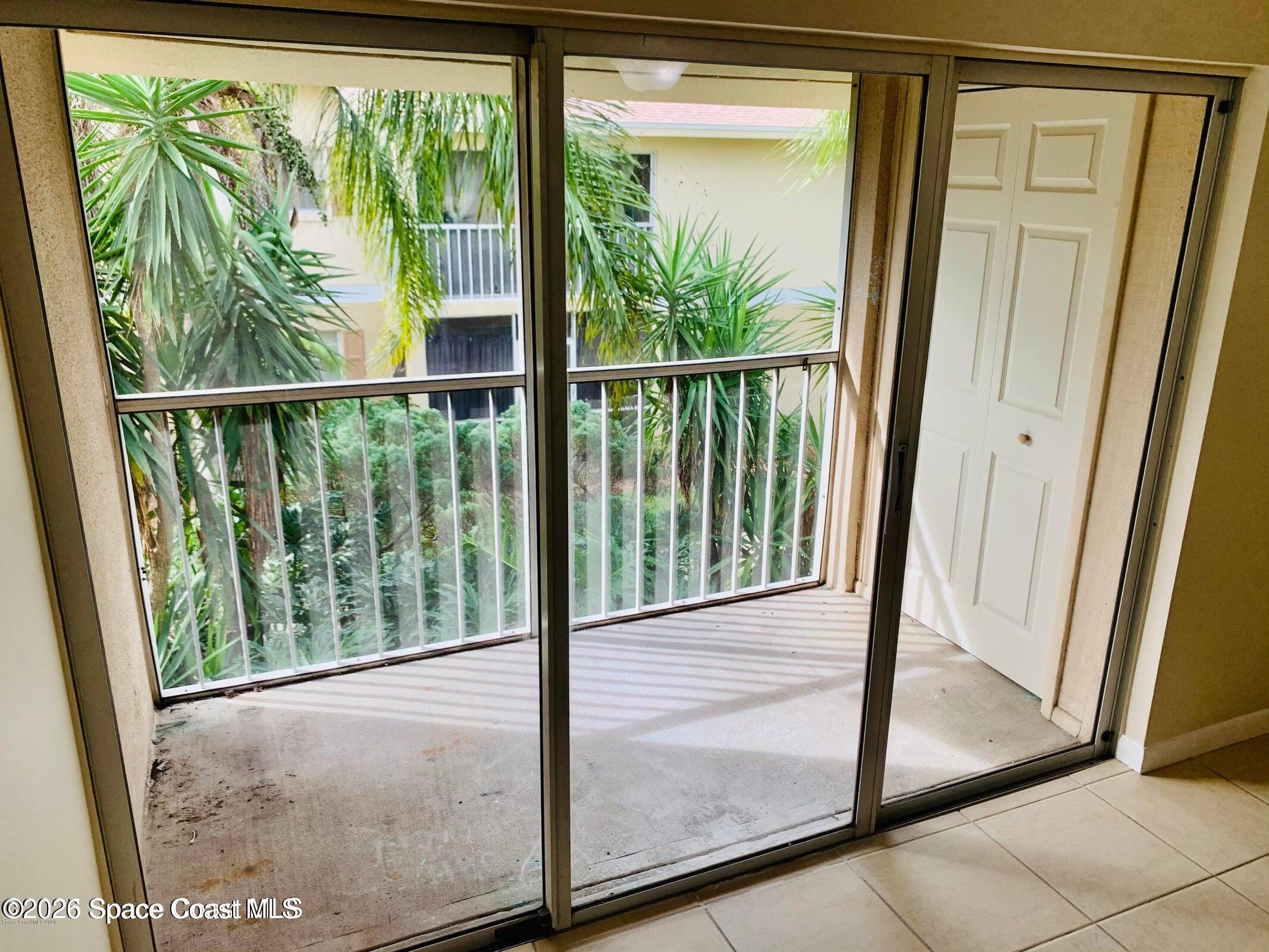 1648 Sunny Brook Lane, Unit M202 Palm Bay, FL 32905 - Photo 4 of 15 a view of a glass door