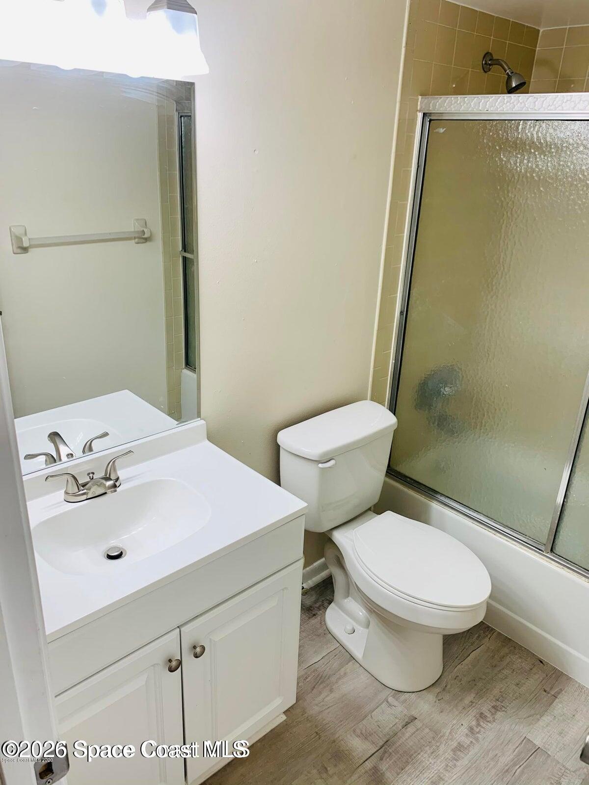 1648 Sunny Brook Lane, Unit M202 Palm Bay, FL 32905 - Photo 7 of 15 a white toilet sitting next to a bathroom sink