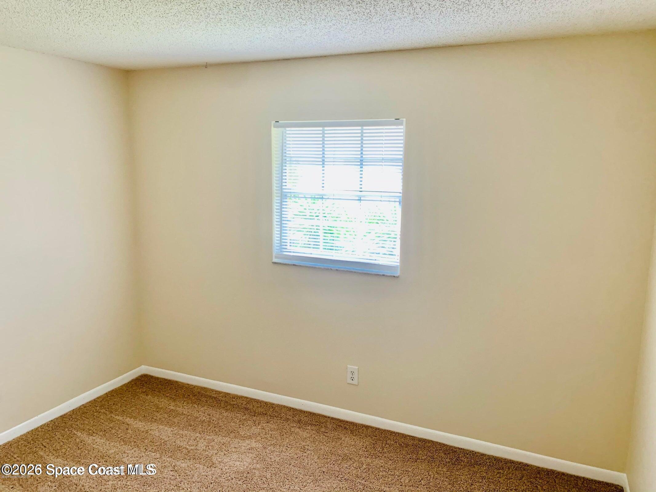 1648 Sunny Brook Lane, Unit M202 Palm Bay, FL 32905 - Photo 8 of 15 an empty room with a window