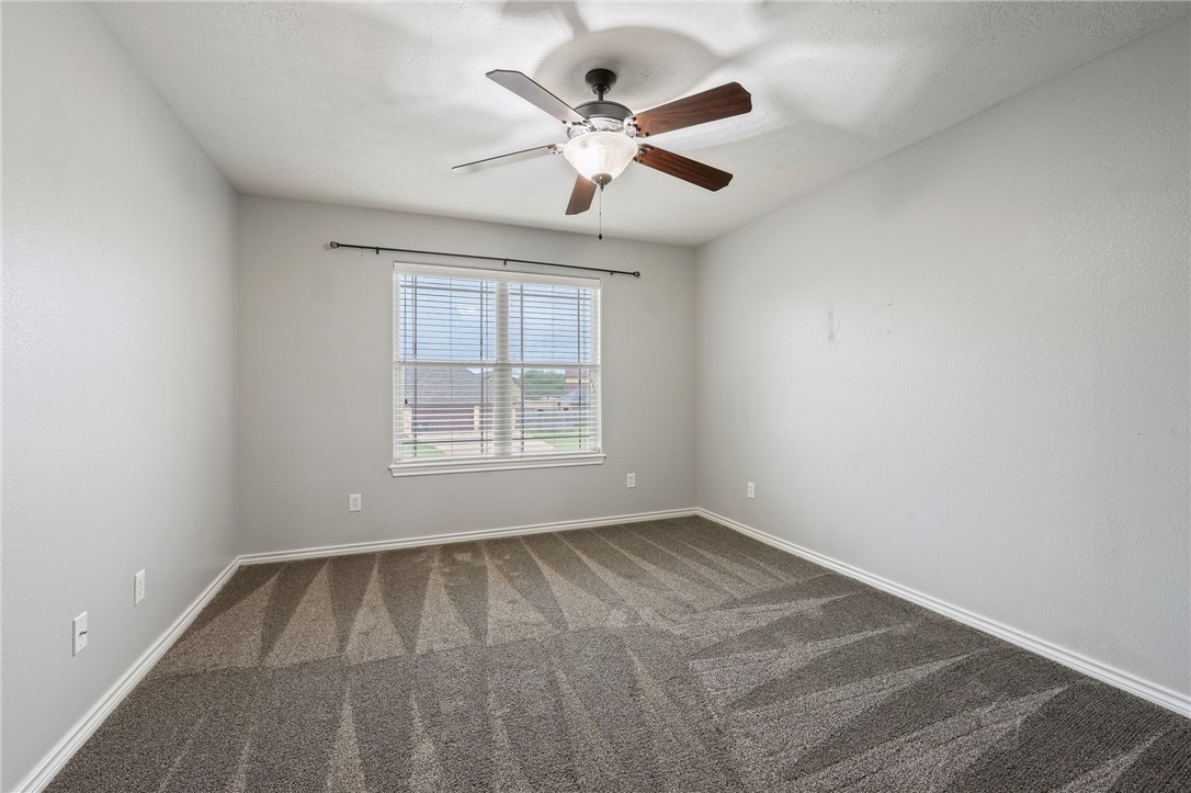 3304 Keefer Loop College Station, TX 77845 - Photo 16 of 21 an empty room with windows and ceiling fan