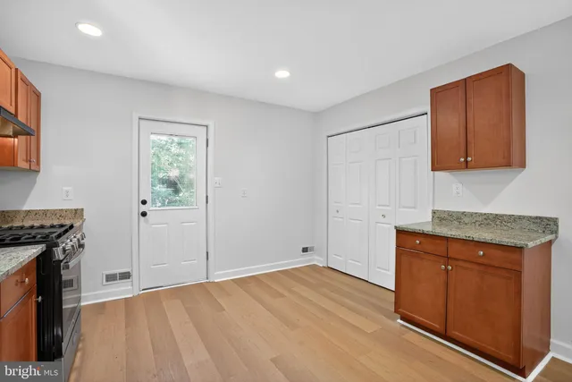 a view of a kitchen with wooden floor and a sink