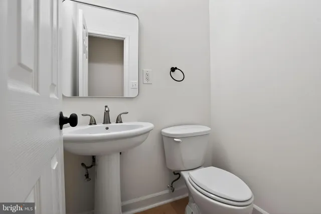 a bathroom with a sink a toilet and mirror