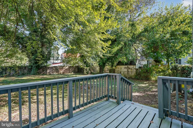 a view of a house with a yard and a tree