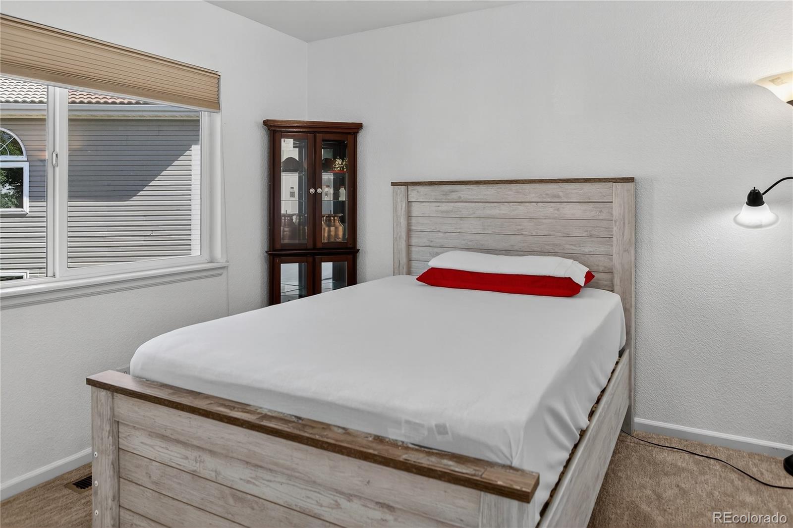 20000 East Mitchell Place, Unit 71 Denver, CO 80249 - Photo 13 of 28 a bed sitting in a bedroom next to a window