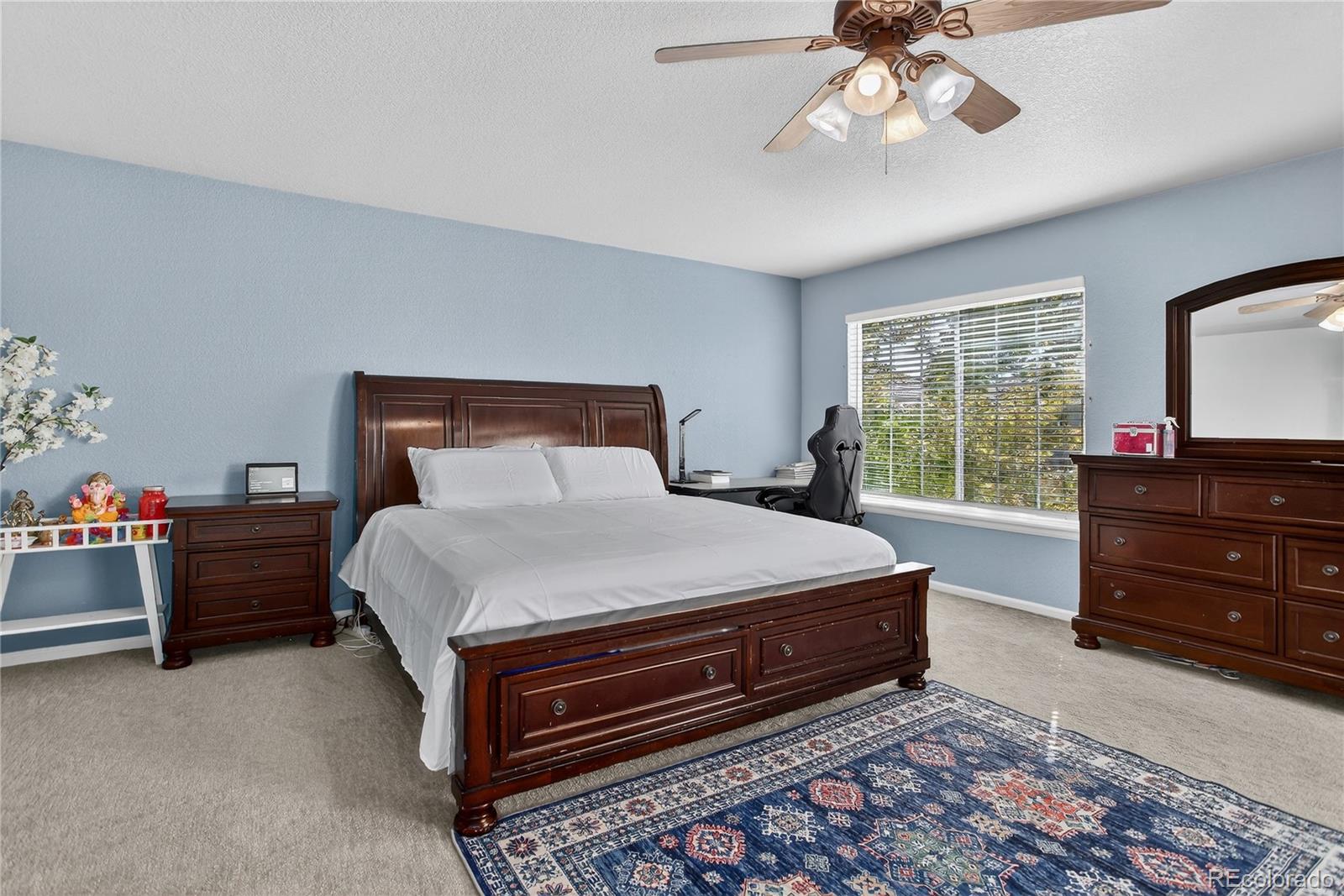 20000 East Mitchell Place, Unit 71 Denver, CO 80249 - Photo 17 of 28 a bedroom with a bed and a chandelier