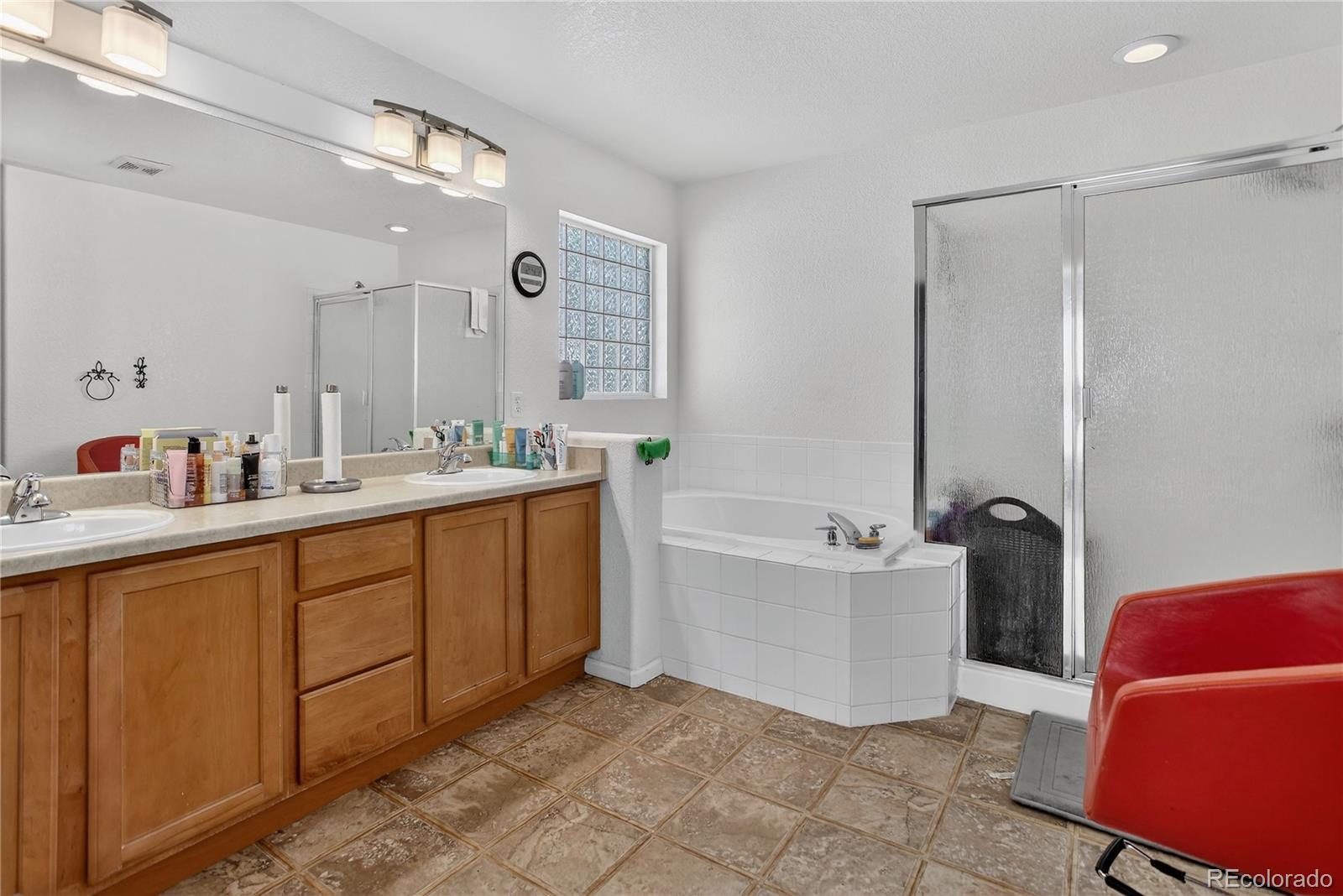 20000 East Mitchell Place, Unit 71 Denver, CO 80249 - Photo 19 of 28 a bathroom with a tub sink and mirror