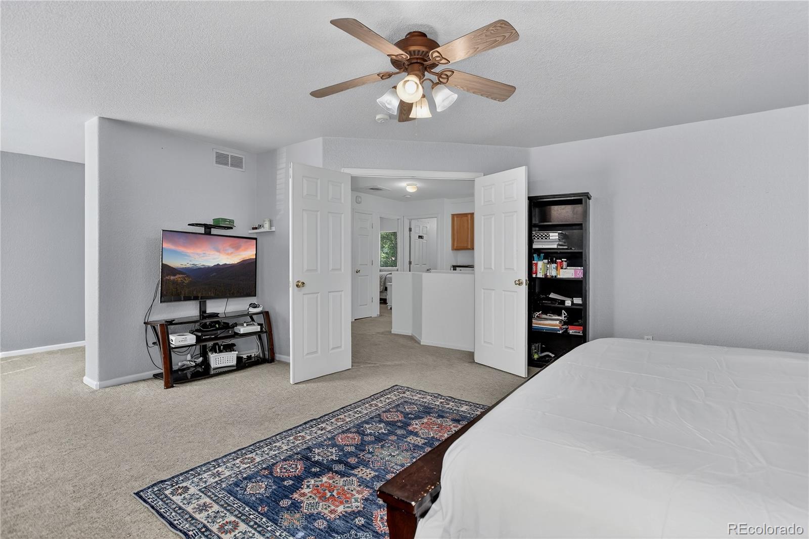 20000 East Mitchell Place, Unit 71 Denver, CO 80249 - Photo 20 of 28 a bedroom with furniture and a chandelier