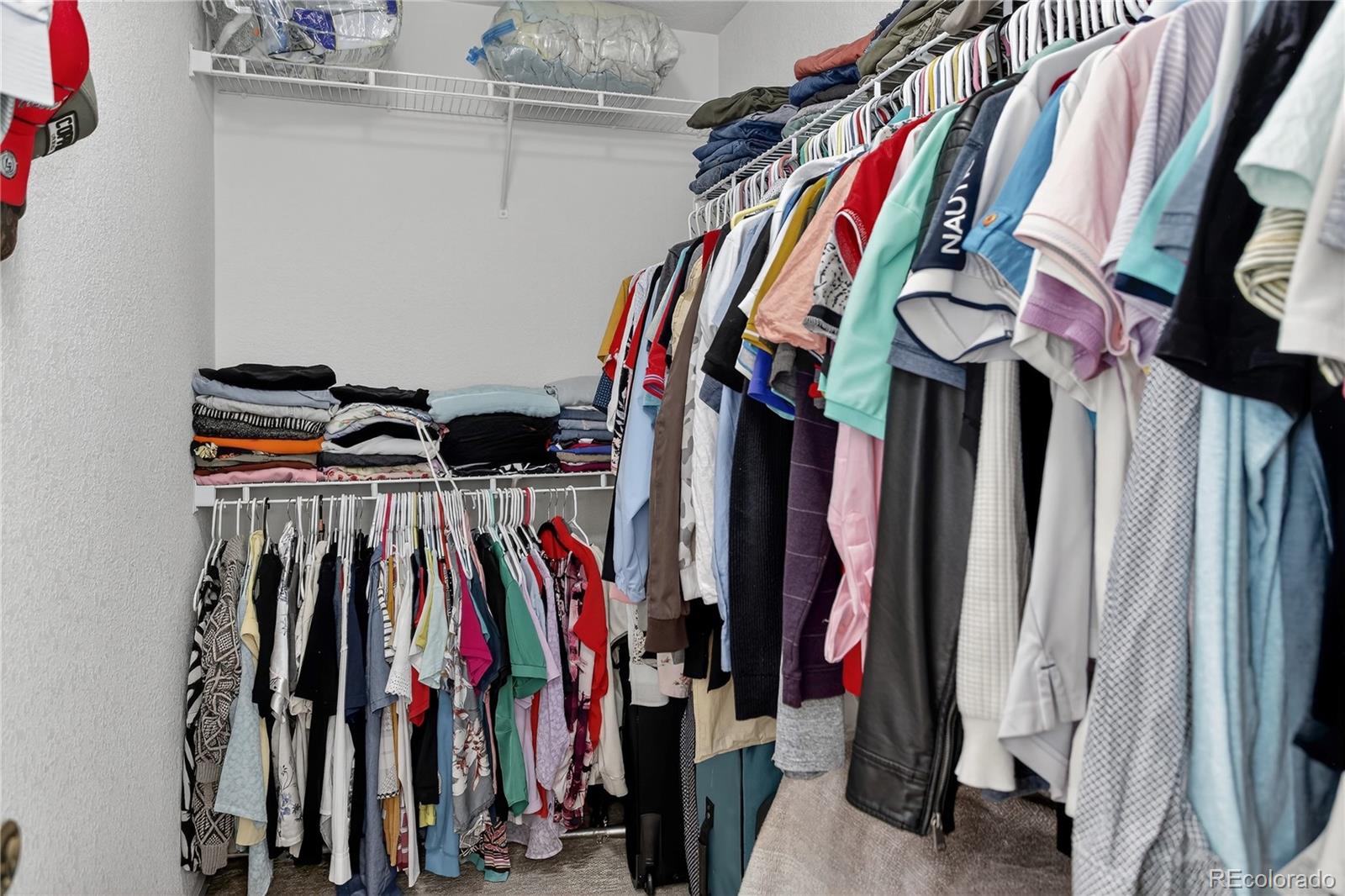 20000 East Mitchell Place, Unit 71 Denver, CO 80249 - Photo 21 of 28 a view of walk in closet with clothes and shoes