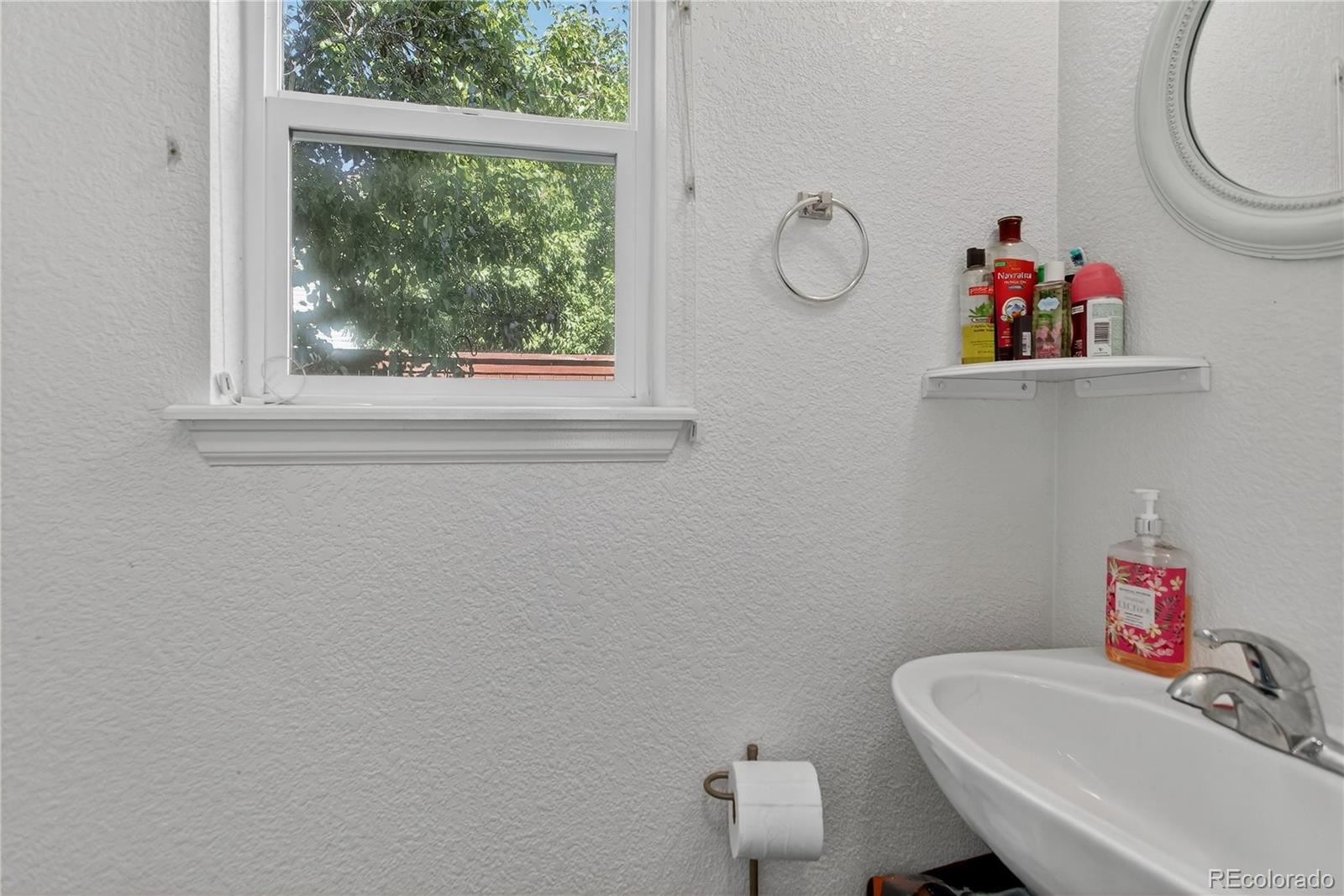 20000 East Mitchell Place, Unit 71 Denver, CO 80249 - Photo 23 of 28 a bathroom with a sink vanity and a toilet
