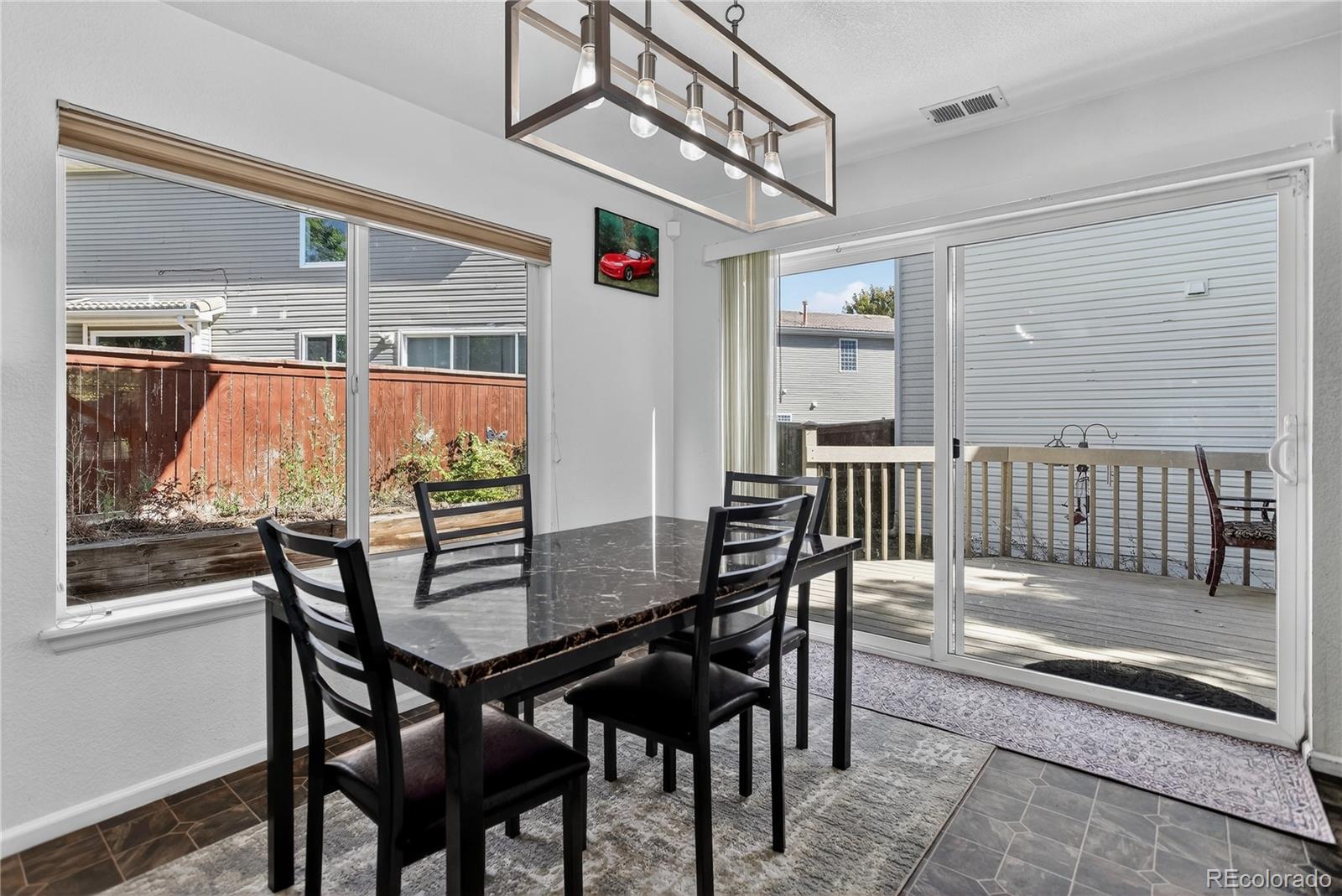 20000 East Mitchell Place, Unit 71 Denver, CO 80249 - Photo 4 of 28 a view of a dining room with furniture and wooden floor