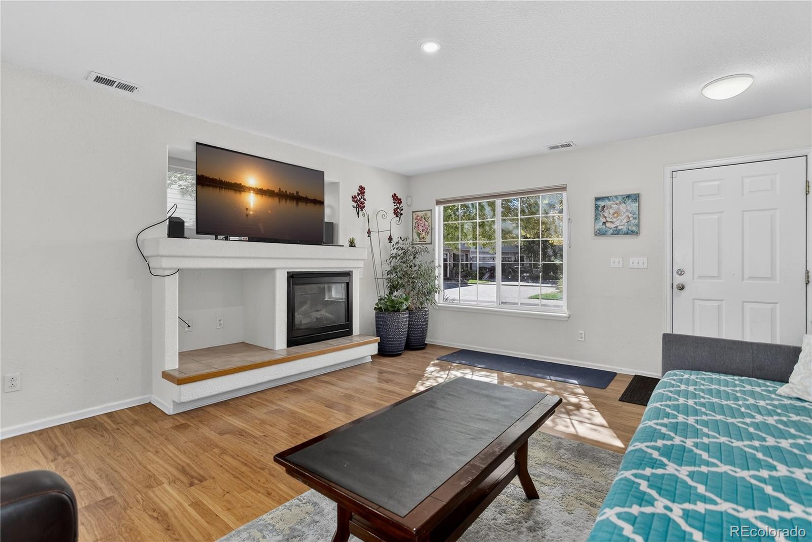 20000 East Mitchell Place, Unit 71 Denver, CO 80249 - Photo 10 of 28 a living room with a flat screen tv and a fireplace
