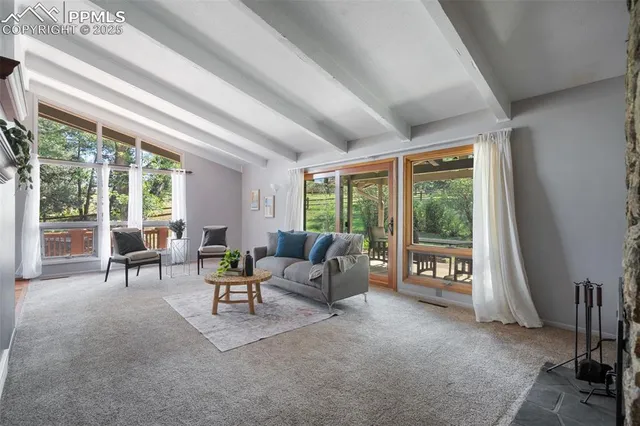 a living room with furniture and large windows